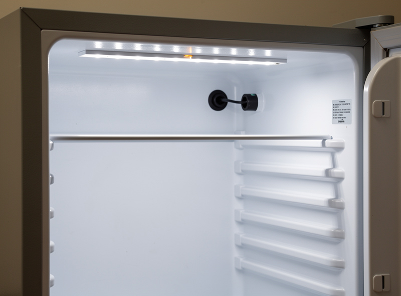 Cool-white LED strip light mounted to the ceiling inside a mini fridge curing chamber with wires sealed through grommets