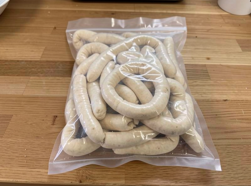 A vacuum-sealed bag of salt-packed natural casings on a wooden counter